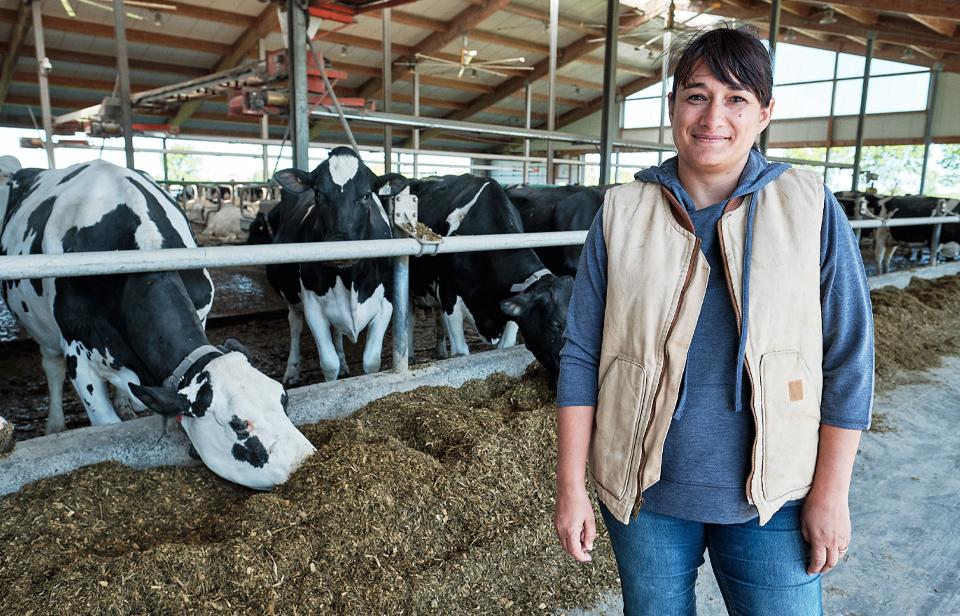 Ana-Maria, in front of her cows in her barn